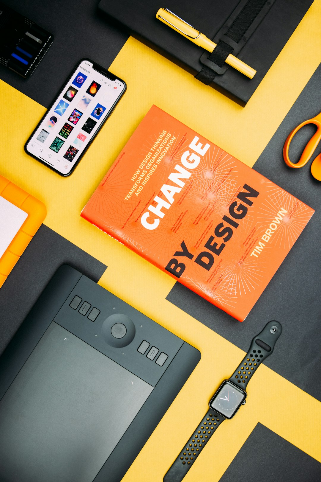 services-03 change-by-design-by-tim-brown-book-beside-smartphone-iyanci0cyrk