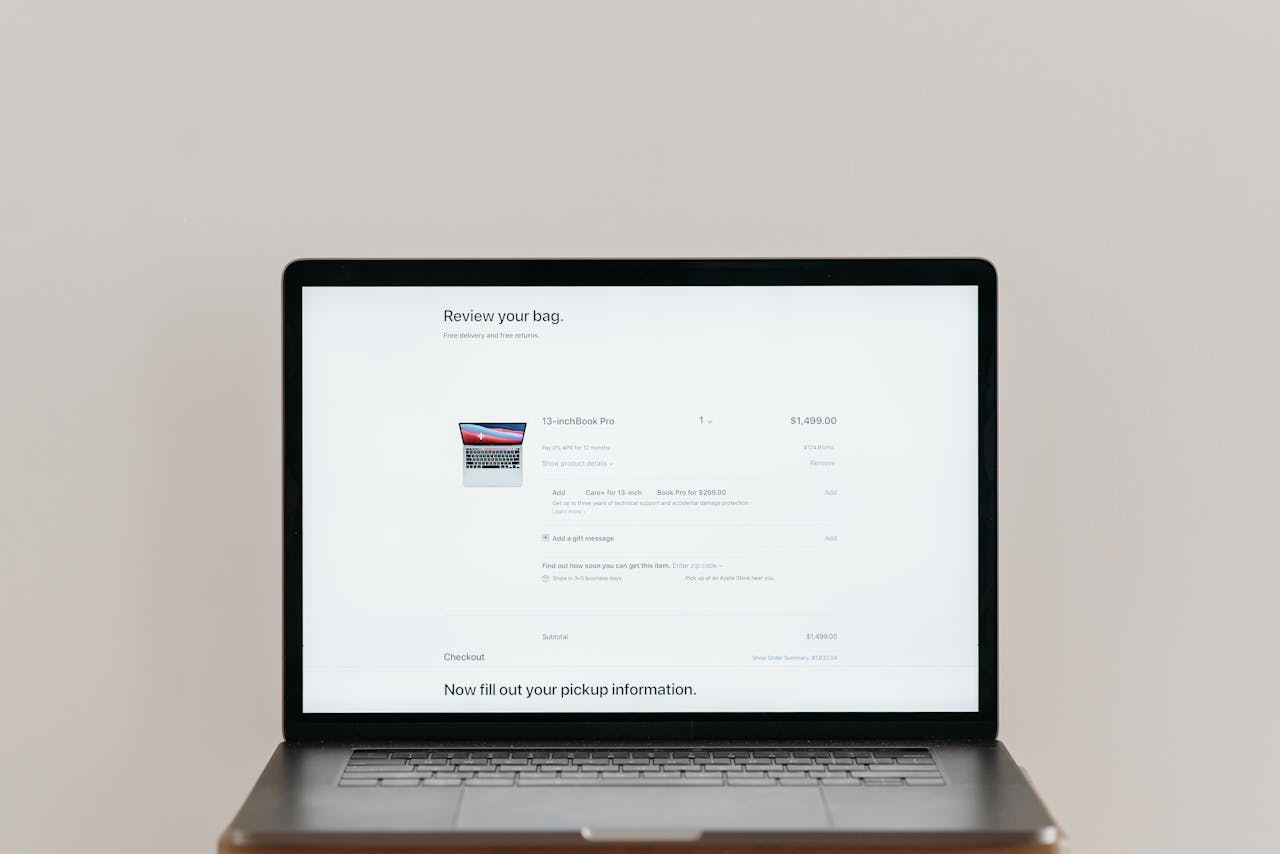 hero-img-01 Minimalist laptop showing an online checkout screen on a white background, ideal for tech context.