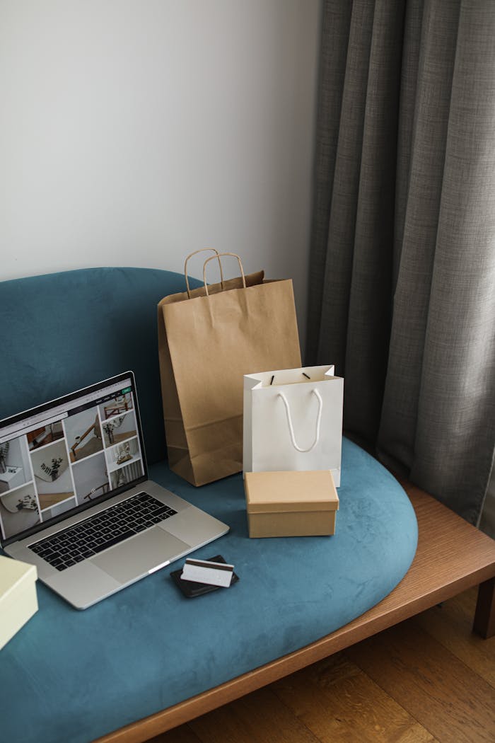 hero-img-02 A cozy indoor scene featuring a laptop with shopping bags, representing modern online shopping.